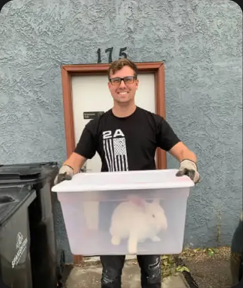RedSky team member outside the office holding a bin